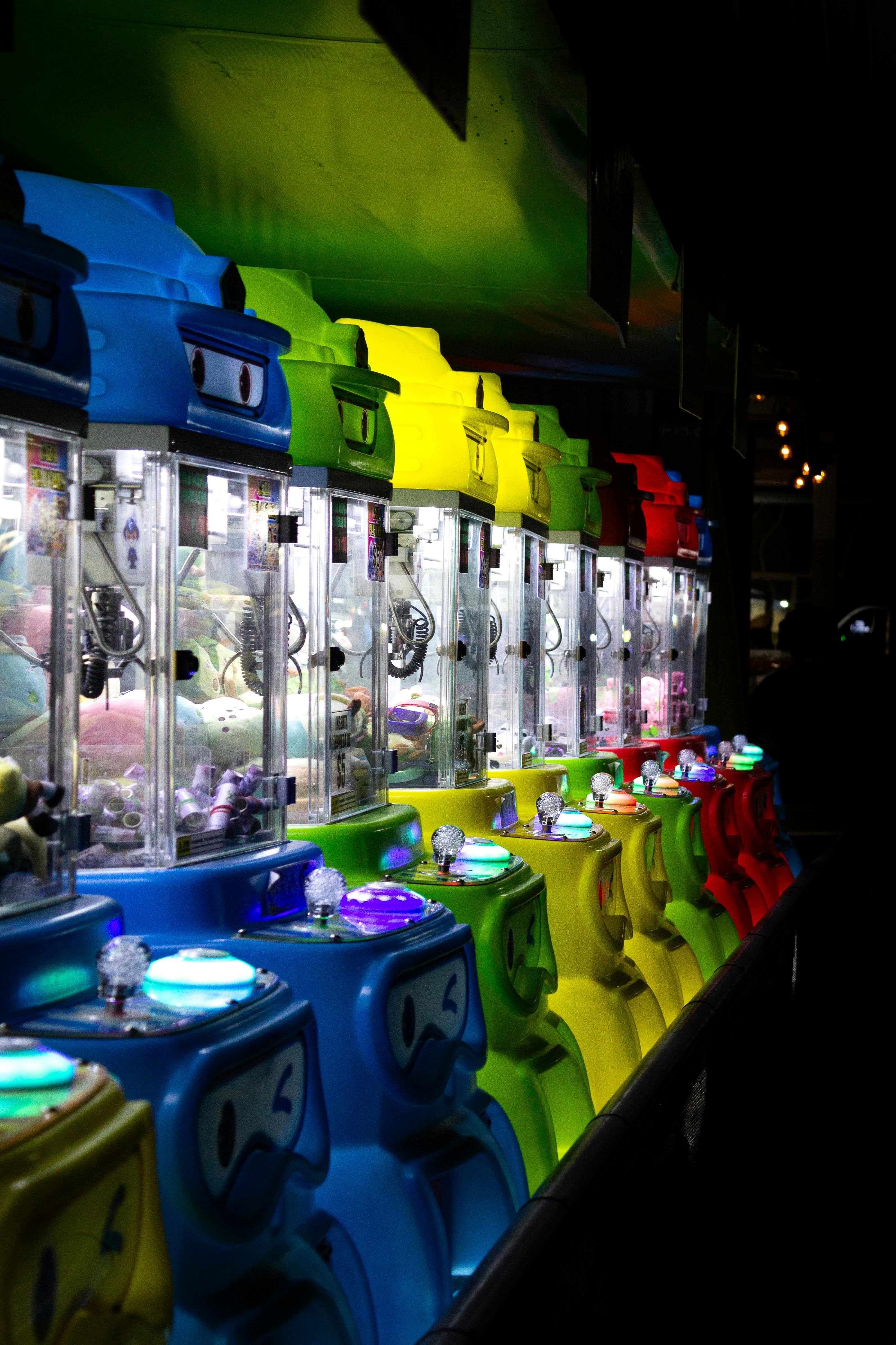 Row of lit-up claw machines